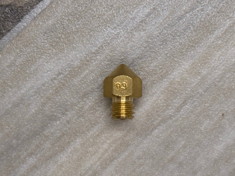 Brass nozzle on a textured stone surface