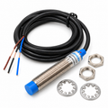 LJ12A3-4-Z/BX NPN proximity sensor with its coiled cable, brown, black and blue leads, two M12 nuts and two star lock washers