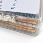 Close-up of the crazed, whitened lid edge next to the hinge clip on the clearance resistor kit case