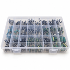 Clear 24-compartment electrolytic capacitor kit case, lid closed, with black, teal and green capacitors visible through the lid