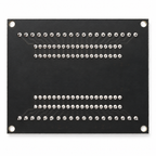 Underside of the ESP32 terminal adapter with the soldered terminal and socket joints and four corner mounting holes