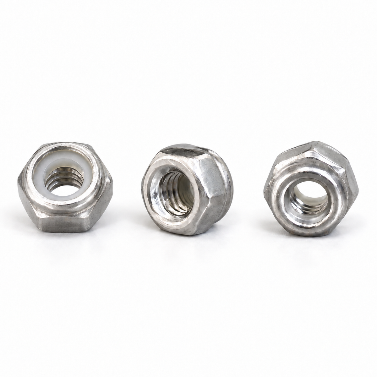 Three identical M3 304 stainless steel nylon insert lock nuts on white