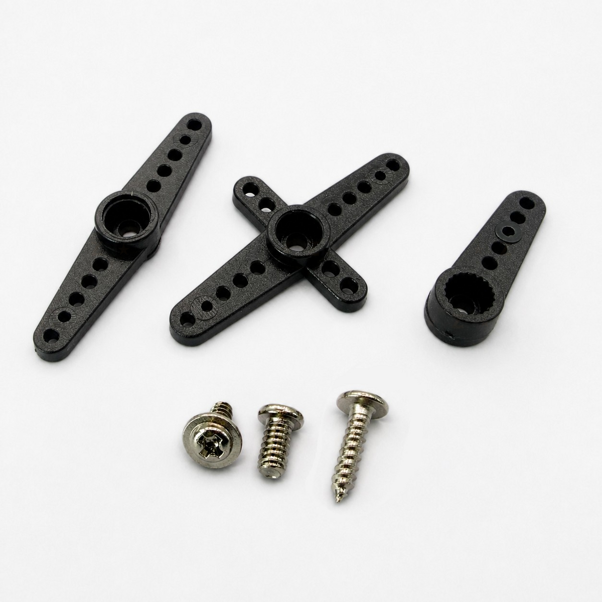 MG90S supplied servo horns and four mounting screws arranged on a white background