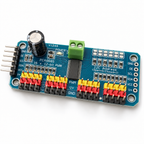 PCA9685 16-channel servo driver board at an angle, showing the 16 three-pin servo headers, screw terminal and 1000uF capacitor